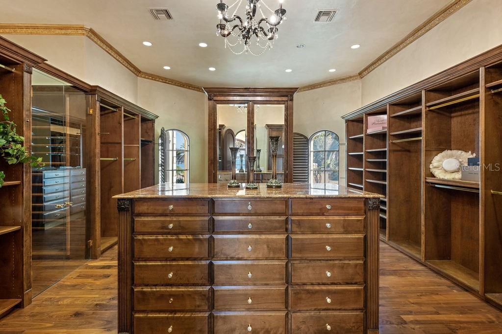 4200 Down Point Lane Windermere, FL 34786 - Photo 31 of 63 a room with a dresser and a chandelier