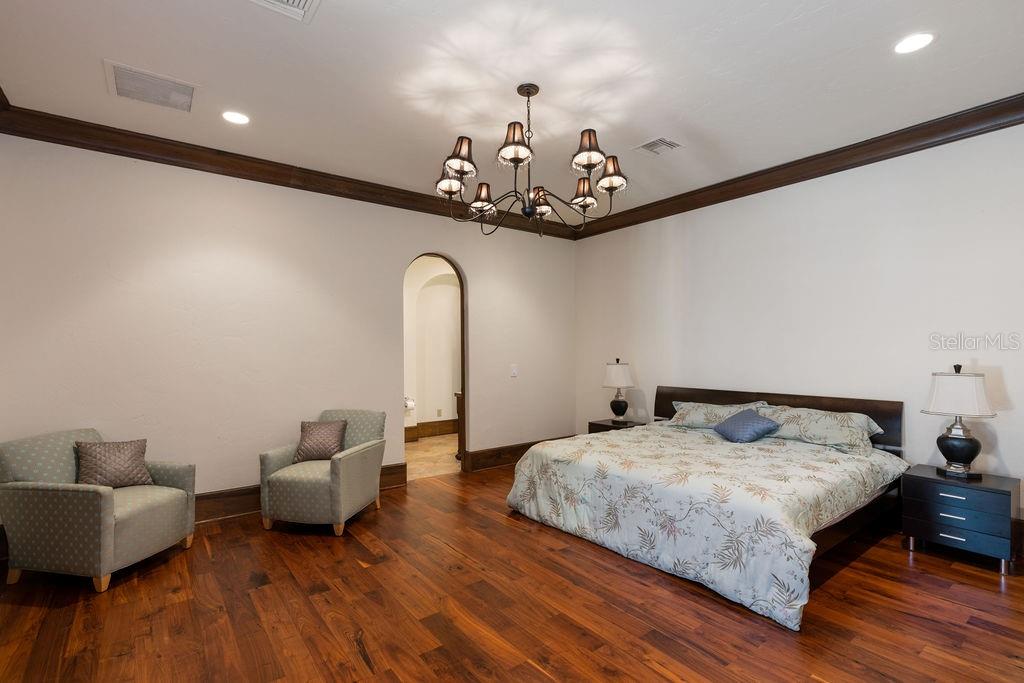 4200 Down Point Lane Windermere, FL 34786 - Photo 54 of 63 a bedroom with bed and a chandelier