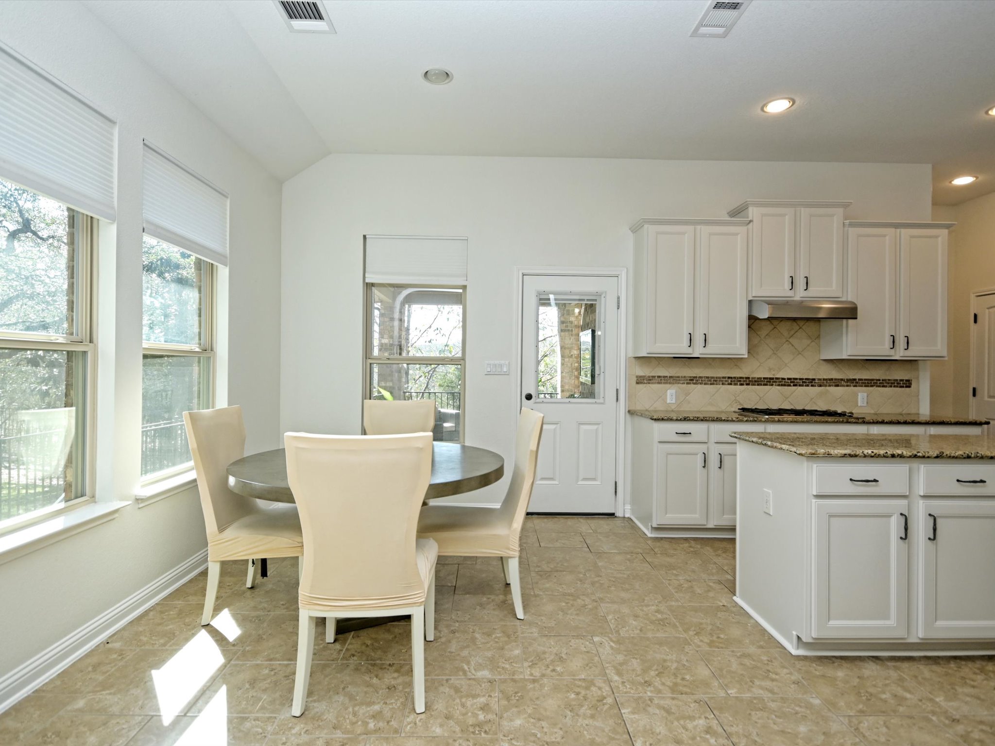 201 Bellagio Drive Austin, TX 78734 - Photo 12 of 31 A spacious dining area stretches off the kitchen providing ample space for a sizable dining table.