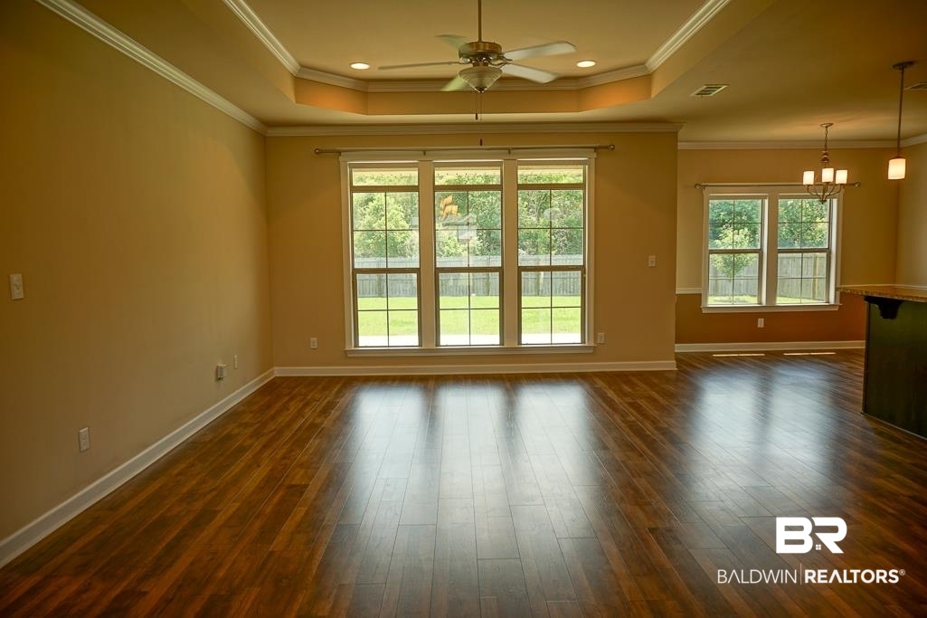 593 Begeman Road Mobile, AL 36608 - Photo 8 of 23 Interior space featuring a wealth of natural light, a tray ceiling, and dark hardwood / wood-style floors