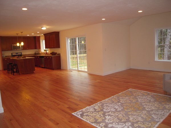Lot 2 Liberty Square Road, Unit 1 Boxborough, MA 01719 - Photo 5 of 12 a open kitchen with kitchen island a sink dishwasher and a refrigerator with wooden floor