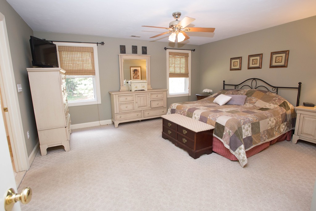 24 Zina Road Hudson, MA 01749 - Photo 12 of 25 a bed sitting in a bedroom chandelier and window