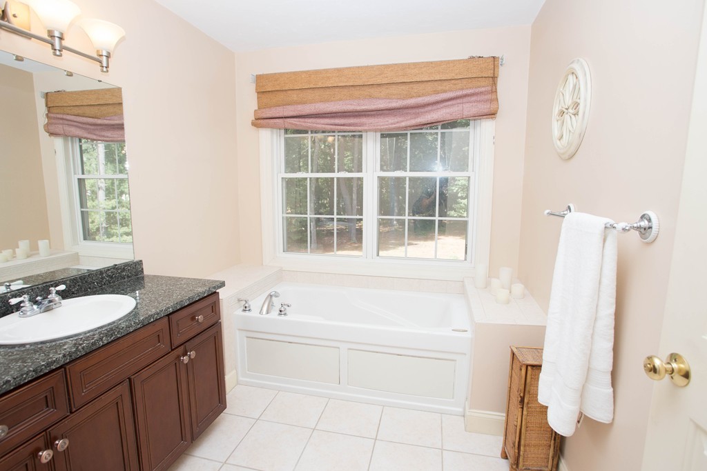 24 Zina Road Hudson, MA 01749 - Photo 14 of 25 a bathroom with a granite countertop sink and a bathtub