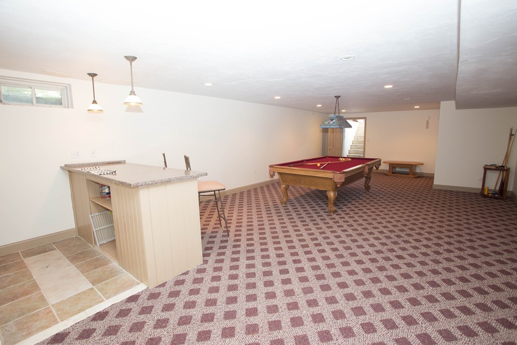 24 Zina Road Hudson, MA 01749 - Photo 20 of 25 a living room with a sink and a table