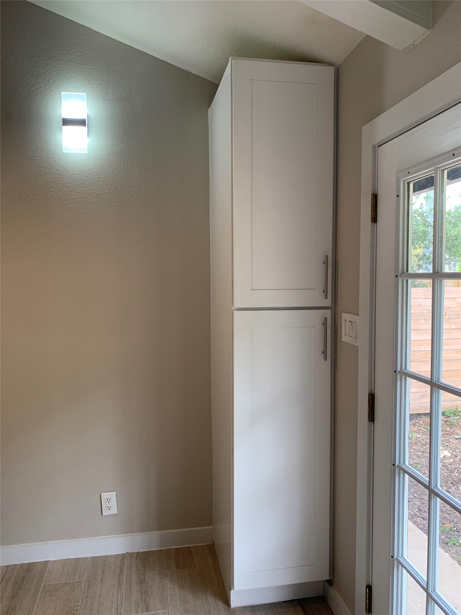6706 Circle S Road, Unit B Austin, TX 78745 - Photo 3 of 18 Floor-to-ceiling cabinetry maximizes storage next to a glass-paneled exterior door.