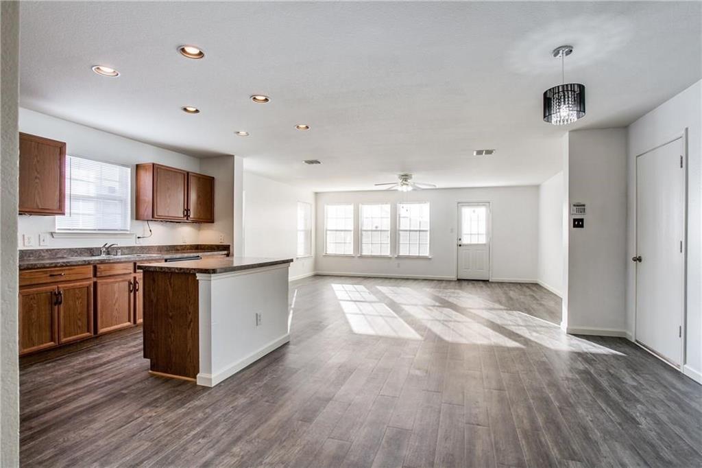 14816 South Spring Ridge Circle Balch Springs, TX 75180 - Photo 3 of 11 a large kitchen with stainless steel appliances granite countertop a stove and a large window