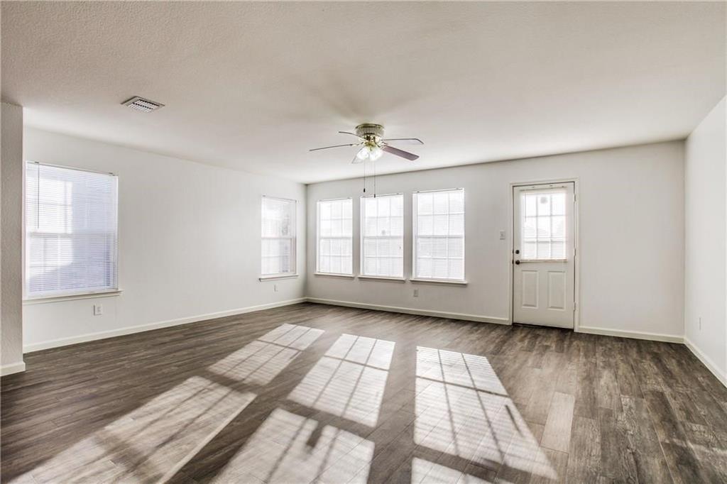 14816 South Spring Ridge Circle Balch Springs, TX 75180 - Photo 4 of 11 a view of an empty room with a window and wooden floor