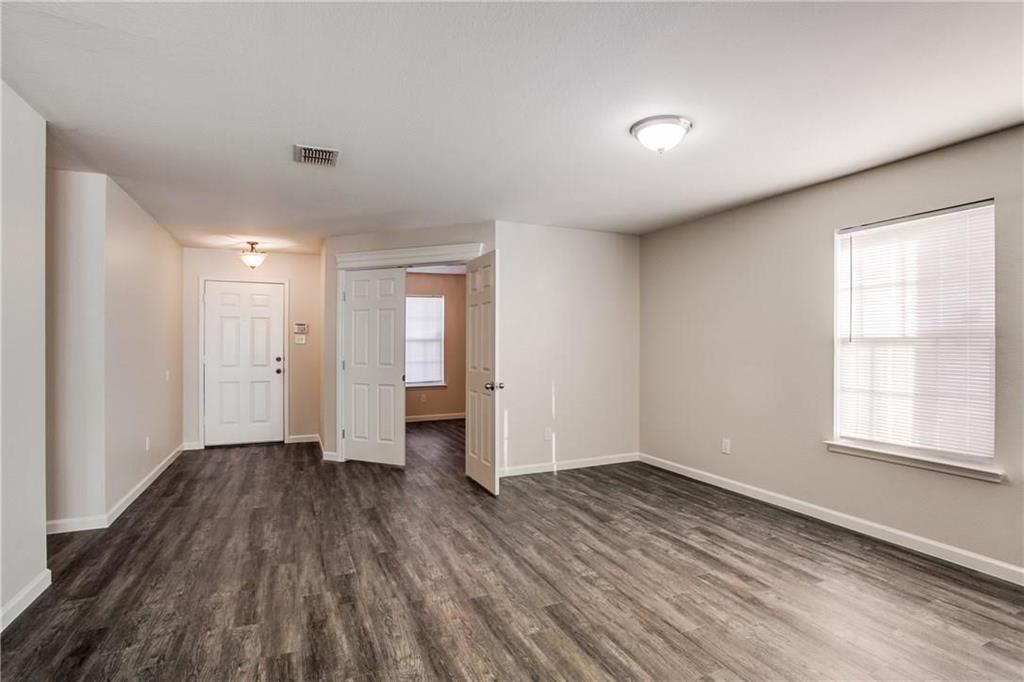 14816 South Spring Ridge Circle Balch Springs, TX 75180 - Photo 5 of 11 a view of an empty room with wooden floor and a window