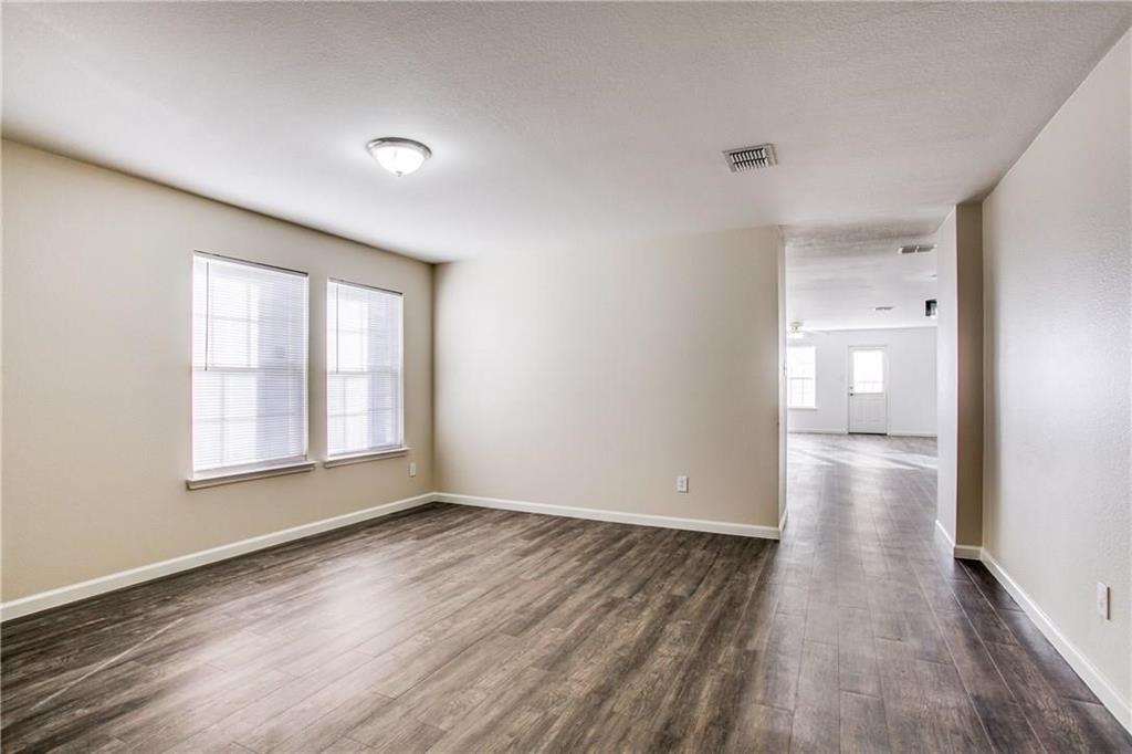 14816 South Spring Ridge Circle Balch Springs, TX 75180 - Photo 6 of 11 a view of empty room with wooden floor and fan