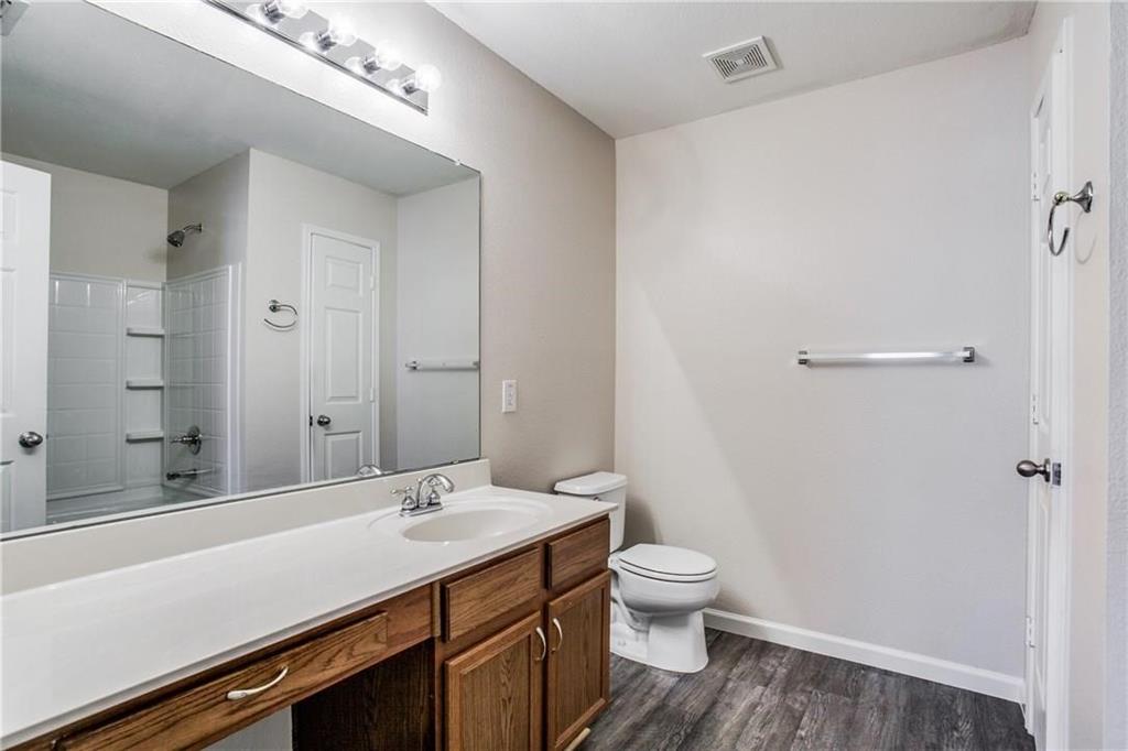 14816 South Spring Ridge Circle Balch Springs, TX 75180 - Photo 8 of 11 a bathroom with a sink a toilet and shower