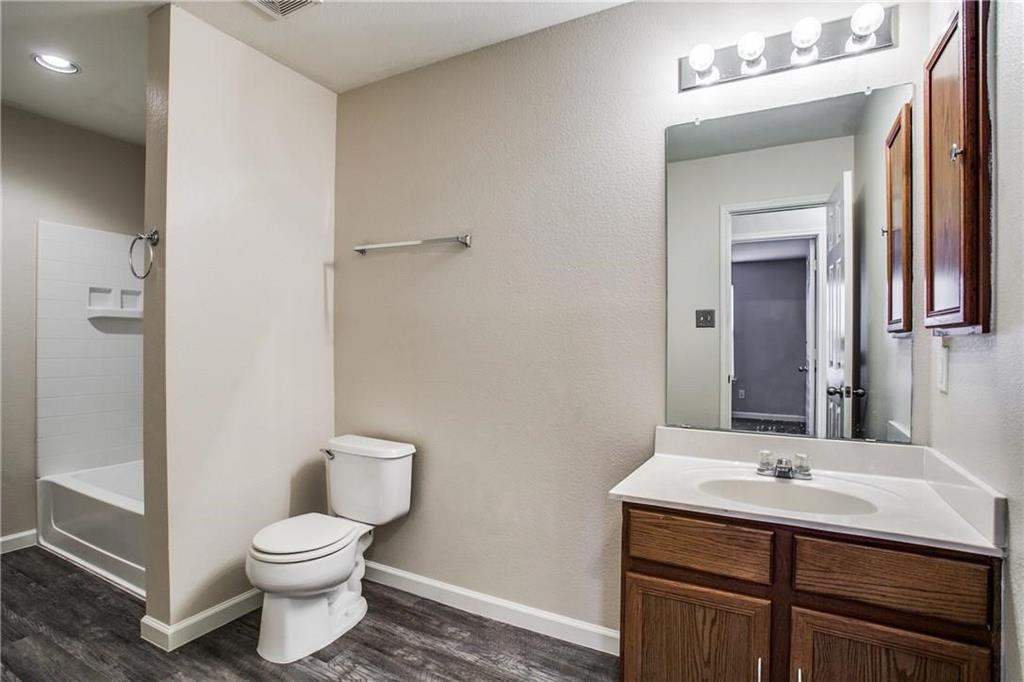 14816 South Spring Ridge Circle Balch Springs, TX 75180 - Photo 10 of 11 a bathroom with a toilet sink and mirror