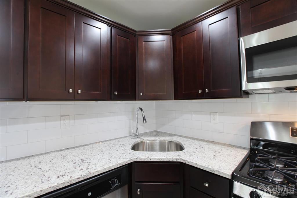 3304 Hana Road Edison, NJ 08817 - Photo 2 of 13 a kitchen with a sink and cabinets