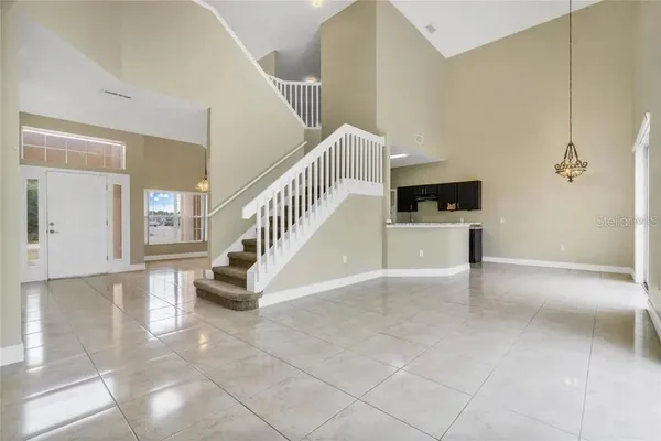 a view of a livingroom with wooden floor and staircase