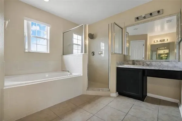 a bathroom with a bathtub sink and mirror