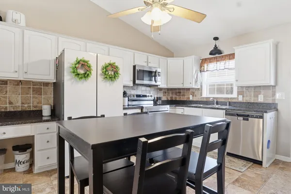 a kitchen with a table chairs stove and microwave