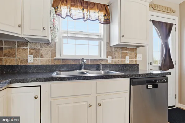 a kitchen with a sink and cabinets