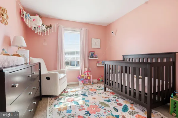 a room with furniture and a baby crib