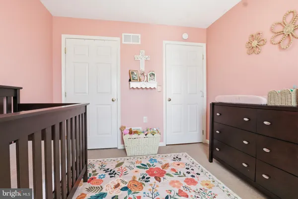 a bedroom with a bed and a dresser in it