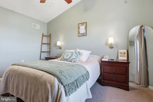 a bedroom with a bed and a mirror