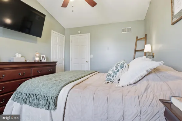 a bedroom with a bed and a tv