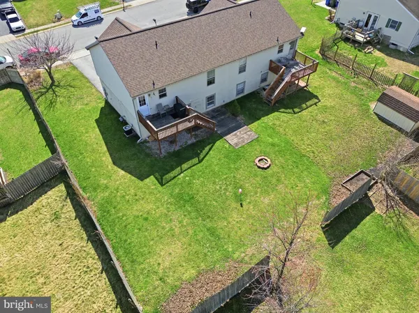 an aerial view of a house with backyard