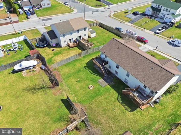 an aerial view of a pool patio chairs and fire pit