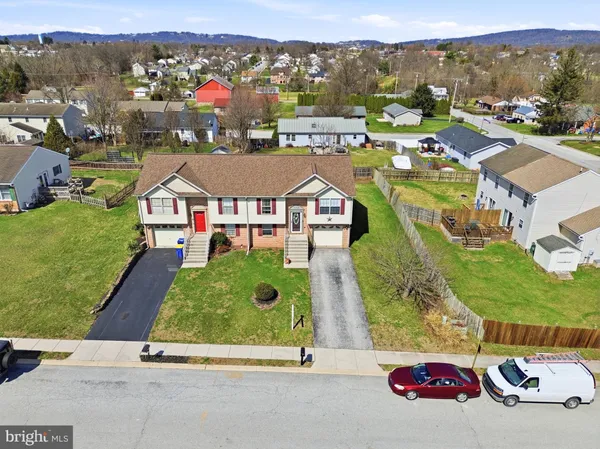 an aerial view of residential houses and street