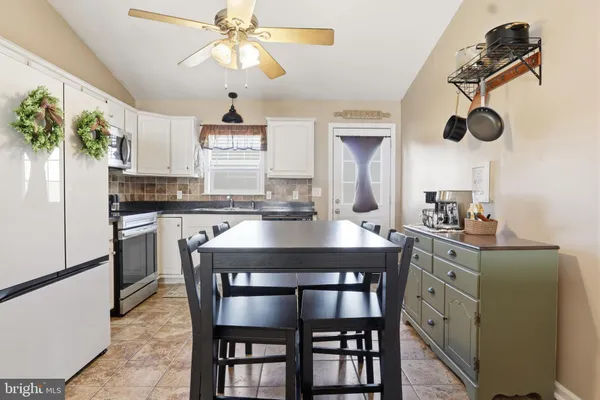 a kitchen with appliances cabinets and furniture
