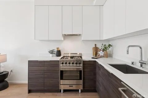 a kitchen with cabinets appliances and a sink