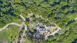 a backyard of a house with lots of green space and trees