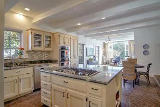 a kitchen with granite countertop a sink and cabinets