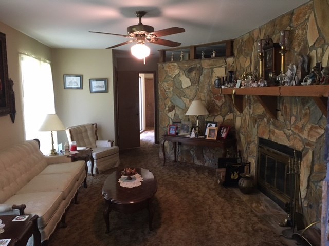 1031 Mt Paran Road Lizella, GA 31052 - Photo 14 of 23 a living room with furniture and a fireplace