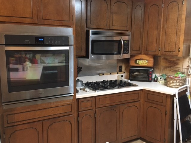 1031 Mt Paran Road Lizella, GA 31052 - Photo 15 of 23 a kitchen with granite countertop wood cabinets and stainless steel appliances