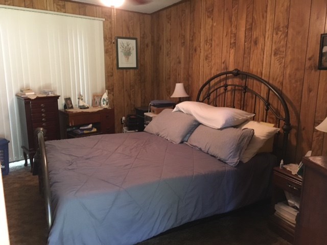 1031 Mt Paran Road Lizella, GA 31052 - Photo 17 of 23 a bedroom with a bed and wooden floor