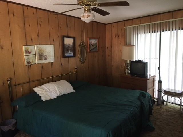 1031 Mt Paran Road Lizella, GA 31052 - Photo 18 of 23 a bedroom with a bed and a chandelier