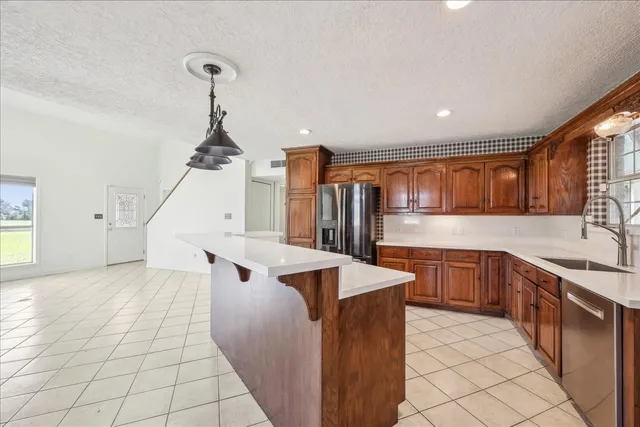 a kitchen with stainless steel appliances granite countertop a sink and cabinets