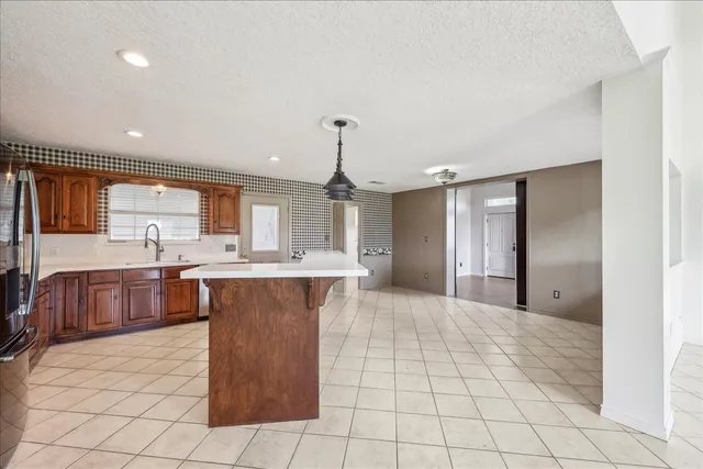 a large kitchen with a large counter top appliances and cabinets