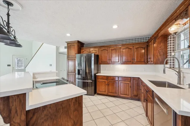 a kitchen with stainless steel appliances granite countertop a sink stove and refrigerator