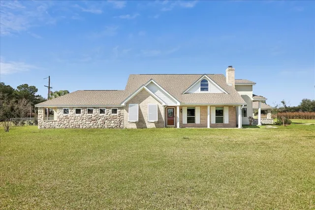 a front view of a house with a garden