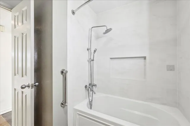 a bathroom with a bathtub and a shower
