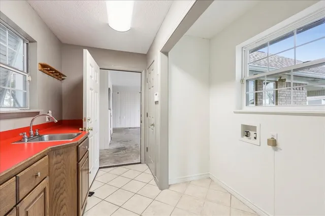 a bathroom with a granite countertop sink a toilet and shower
