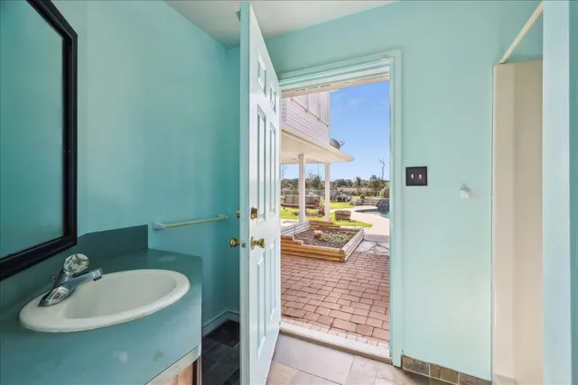 a bathroom with a sink a mirror and a shower