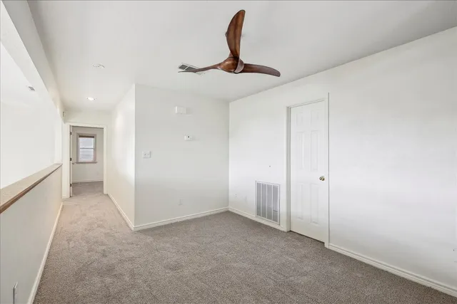 a view of a room with a sink and cabinets