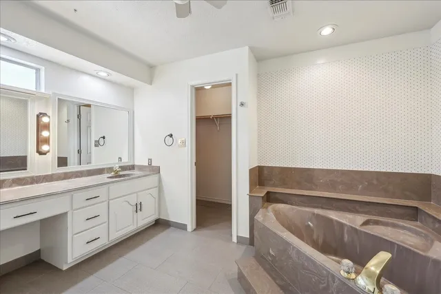 a bathroom with a tub a sink and a