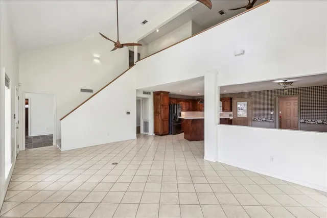a view of a hallway with an entryway and livingroom