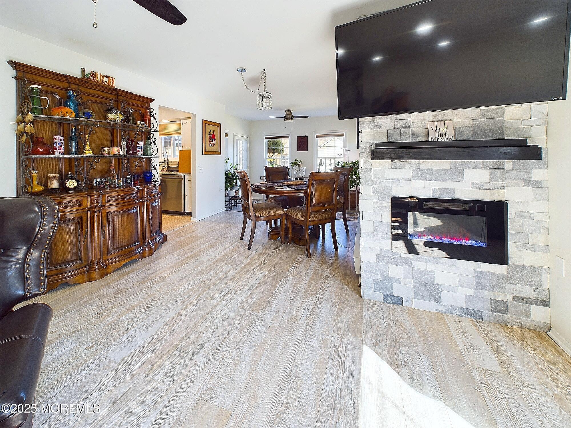 24 B Medford Road Whiting, NJ 08759 - Photo 16 of 42 a living room with furniture a fireplace and kitchen view