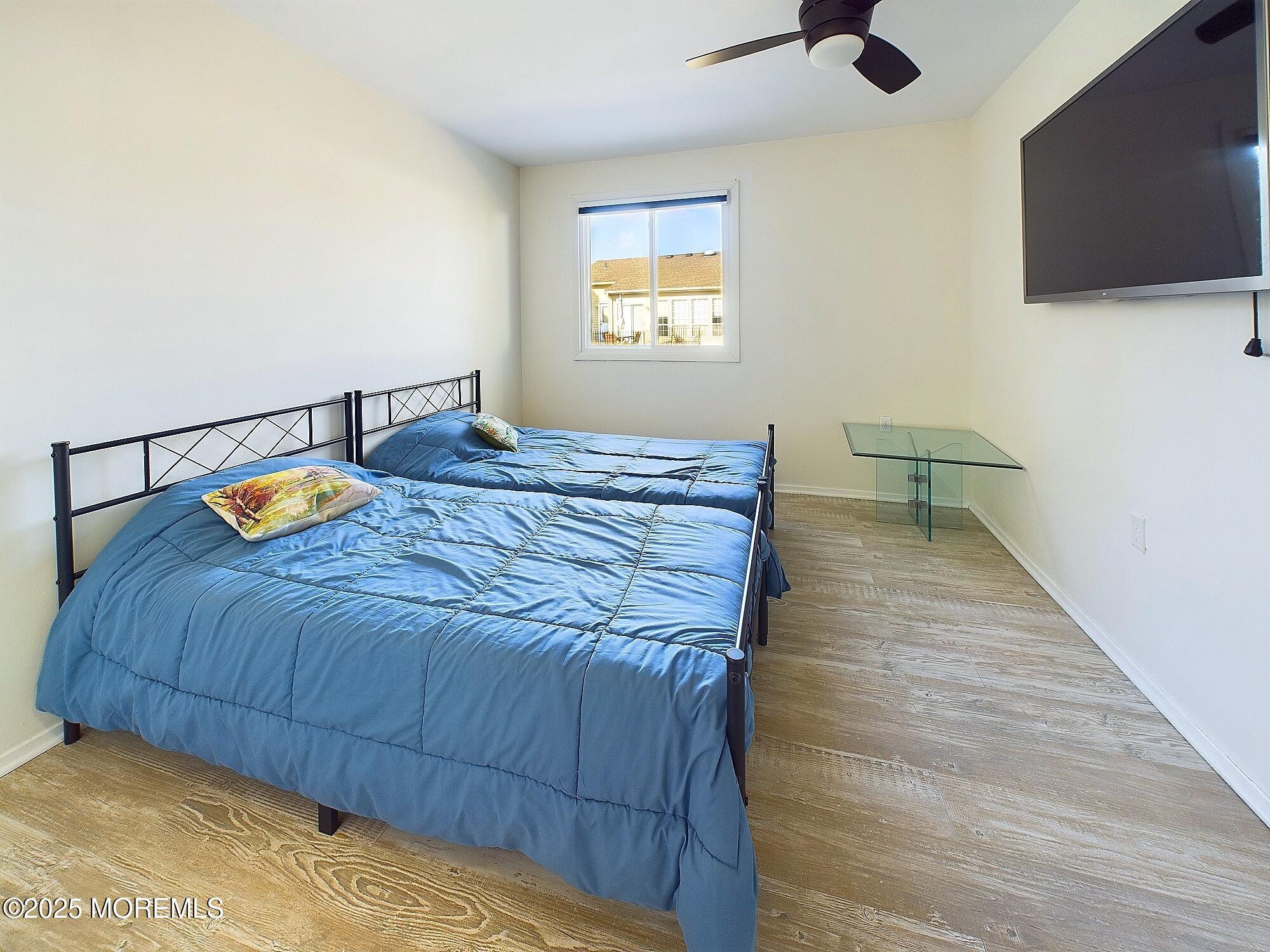 24 B Medford Road Whiting, NJ 08759 - Photo 28 of 42 a bedroom with a bed and flat screen tv
