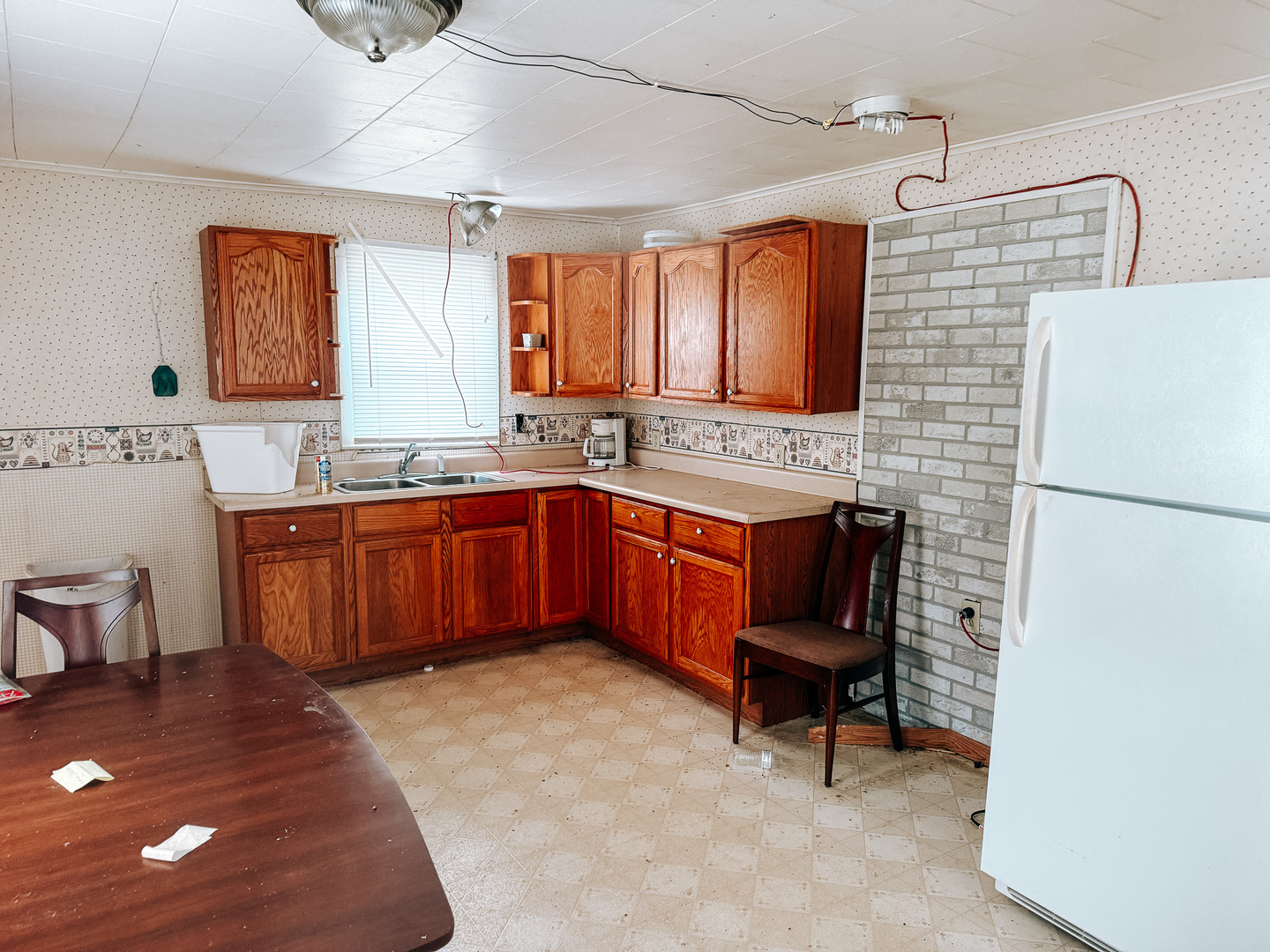 2571 East 1300 North Road Sheldon, IL 60966 - Photo 10 of 20 a kitchen with a sink and wooden cabinets