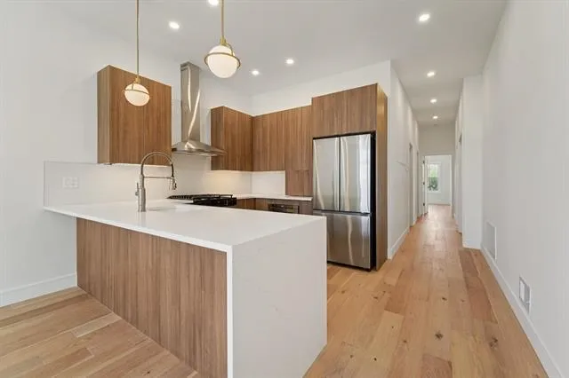 a kitchen with refrigerator and a sink