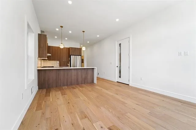 a view of kitchen and wooden floor
